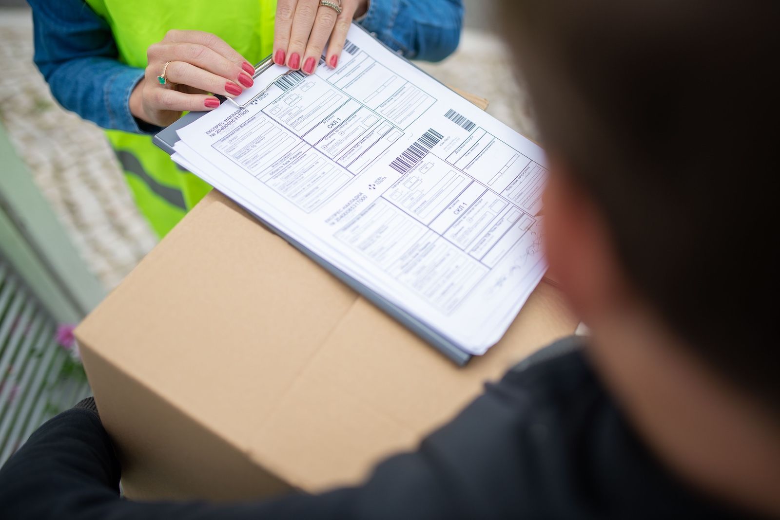 Courier signing for a hand-carried shipment