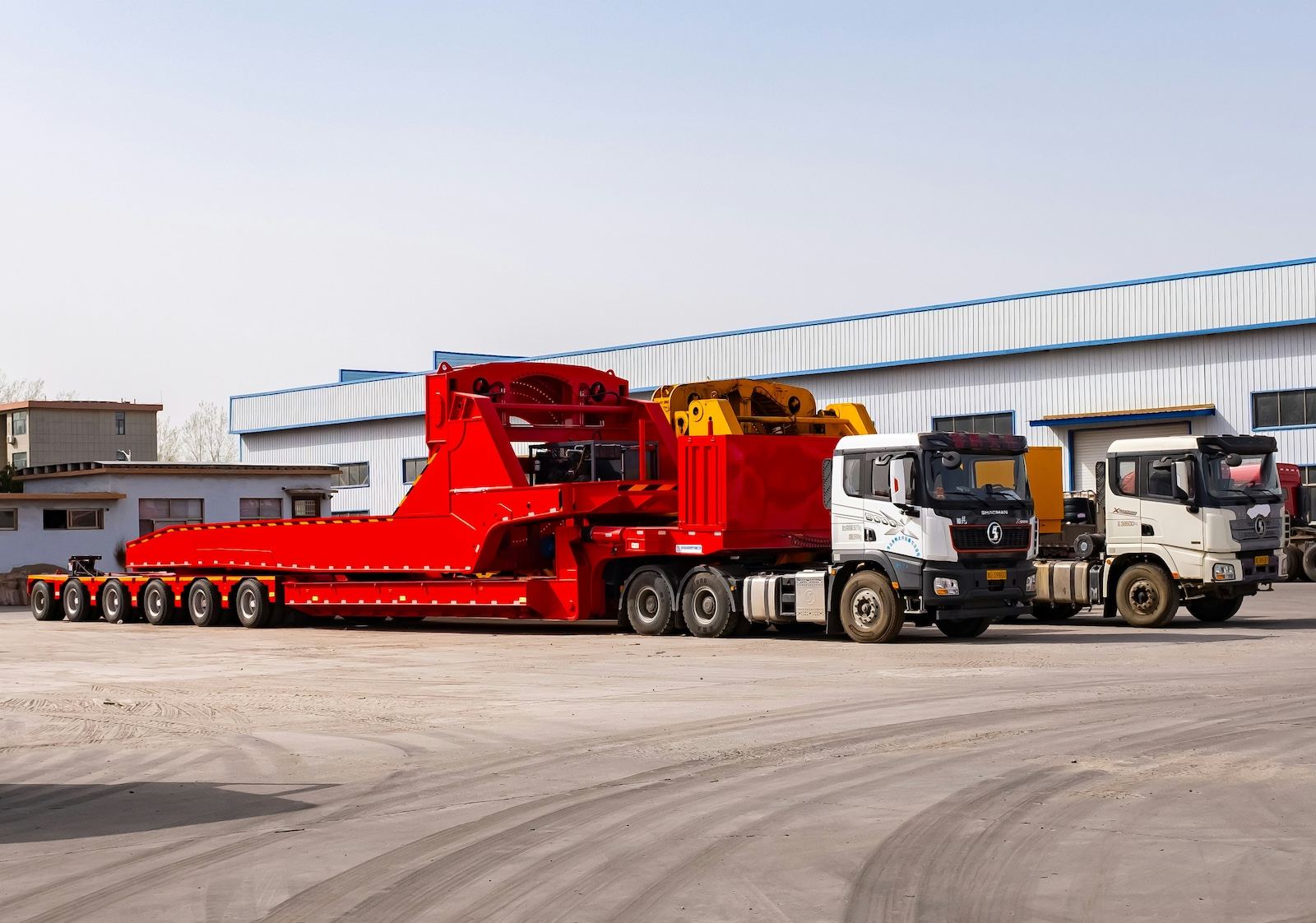 Heavy-haul lowboy trailer carrying oversized equipment